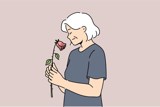 Elderly woman feels fading and weakening health or approach of death, holds withered rose. Widow experiences apathy due to age fading, for concept of aging and importance moral support for retirees