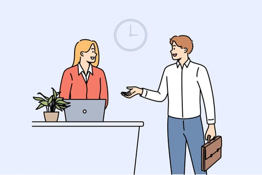 Man rents hotel room talking to administrator standing near reception desk with laptop. Successful businessman checks into hotel during corporate trip to attend professional seminar.