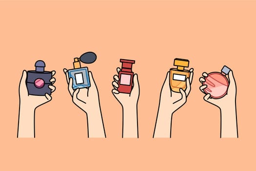 Bottles of perfume in hands of women choosing new scent to create desired look when going to party. Assortment of fragrances in perfume shop, with various essences and extracts for eau de toilette