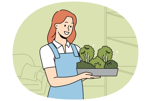 Smiling woman in apron holding box with greenery in hands. Happy girl with microgreen container work in greenhouse. Vector illustration.