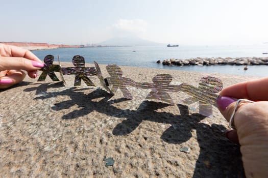 turn around of paper figures with Naples  backround,wallpaper