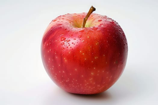 A vibrant red apple contrasts beautifully against a pristine white table, creating a visually striking and artistic scene.