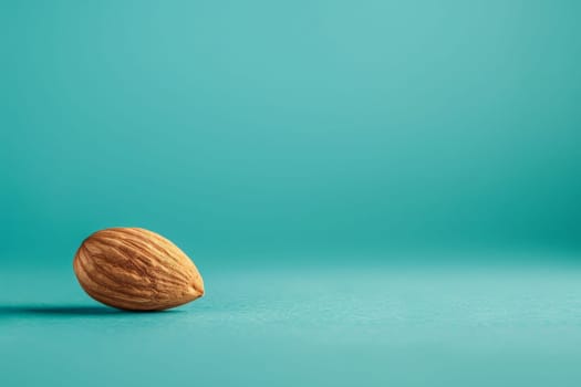 A single almond sits prominently on a bold blue background, offering a stark contrast in color and texture.