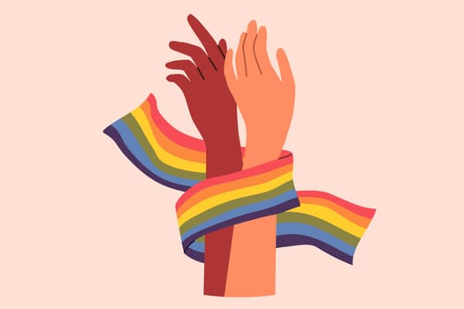 Hands of non-binary couple holding LGBT flag symbolizing love and unity between transgender and gay or lesbian. Pride month concept to promote the idea of tolerance towards LGBT people.