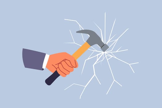 Glass breaks from blow from hammer held by hand of man trying to destroying unnecessary mirror partition. Concept of destroying barrier or vandalism during office robbery through window