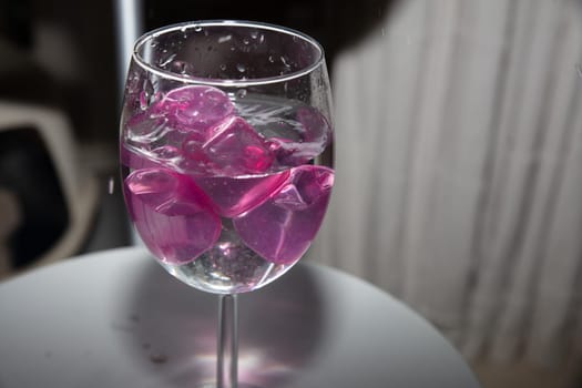 empty glass with ice cubes on white background