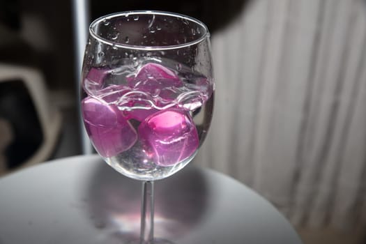 empty glass with ice cubes on white background