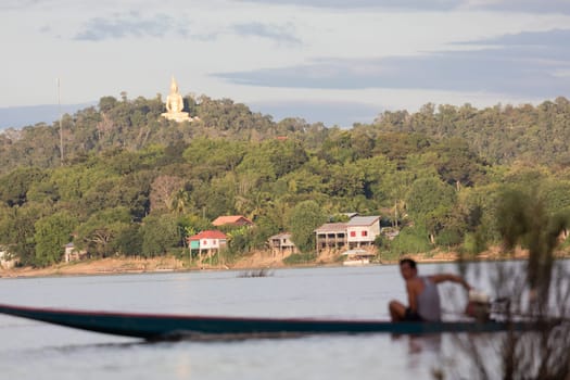 Golden giant Buddha statue on Mekong river