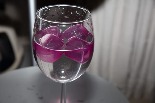 empty glass with ice cubes on white background