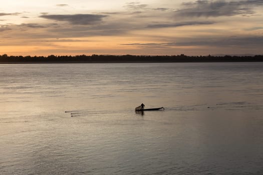 Sunset on Mekong river with fisherman, Laos