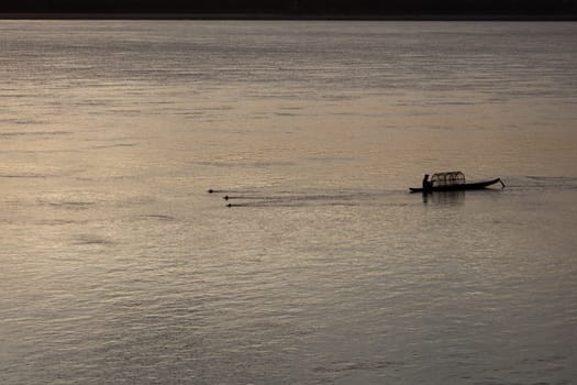 Sunset on Mekong river with fisherman, Laos