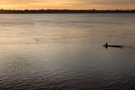 Sunset on Mekong river with fisherman, Laos