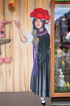 Painting of a woman with traditional clothes, store at the Black Forest, Lake Titisee Neustadt in Germany, Bollenhut with woolen pompoms, 30.03.2024