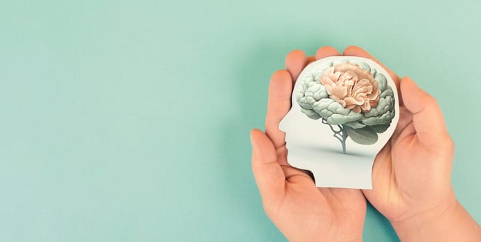 Hands holding head, human brain grows from tree, self care and mental health concept, positive thinking, creative mind