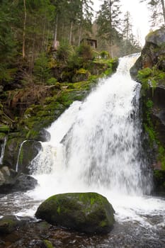 Triberg waterfall in the Black Forest, highest fall in Germany, Gutach river plunges over seven major steps into the valley, wooden bridge
