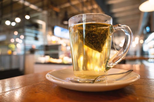 Glass of green tea in a cafe, hot drink with herbs, breakfast in a restaurant, anti inflammatory natural medicine, detox