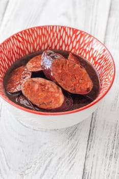 Bowl of chorizo sausage cooked in red wine