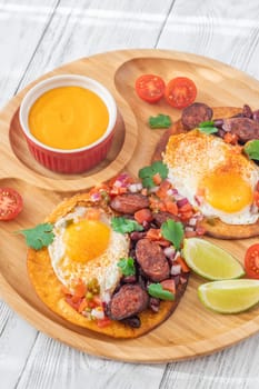 Chorizo and egg tostadas with cheddar cheese sauce