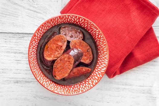 Bowl of chorizo sausage cooked in red wine