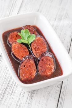 Bowl of chorizo sausage cooked in red wine