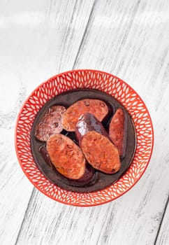Bowl of chorizo sausage cooked in red wine