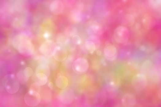 A festive abstract gradient orange pink red and green background texture with glitter defocused sparkle bokeh circles and stars. Card concept for Happy New Year, party invitation, valentine or other holidays.
