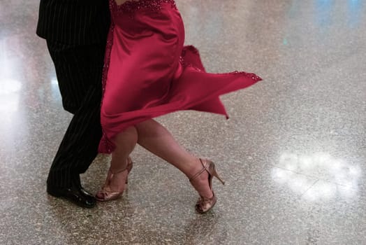 Detail of tango dancers in milonga ballroom