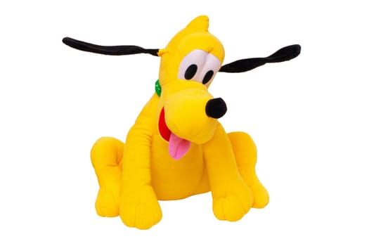 Plush toy dog isolated. Childrens toy stuffed animals. Close up of a playful yellow funny cute sitting toy plush toy dog on white background. Kids playing.