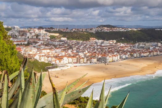 Aerial view over Nazaré town, Portugal, down to beach and Atlantic Ocean