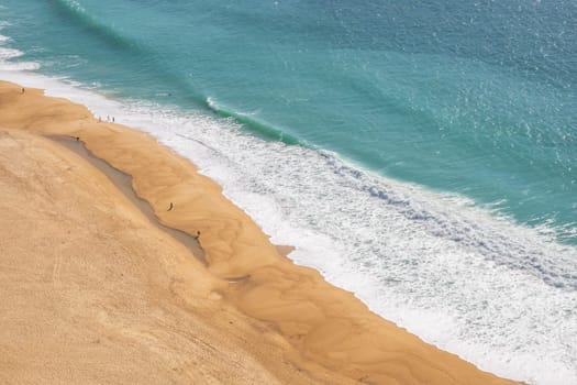 Nazaré beach showing beach and ocean photographed in Nazaré, Portugal