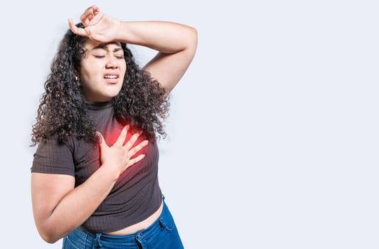 People with heart problems isolated. Latin woman with heart pain on isolated background. Young woman with tachycardia