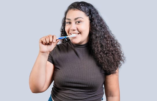 Portrait of smiling woman brushing his teeth isolated with copy space. Beautiful young woman brushing teeth isolated