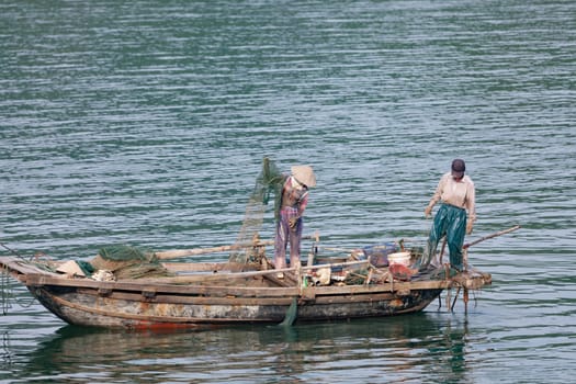 Fisherman in Halong bay, Vietnam. UNESCO World Heritage Site.