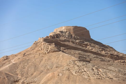 tower of silence , Yazd, Zoroastrian tradition considered a dead body to be nasu, unclean. To preclude the pollution of earth or fire  the bodies of the dead are placed a top a dakhma and so exposed to the sun and to scavenging bird