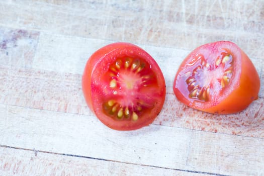 Tomato and black truffle isolated on a wooden cutting board