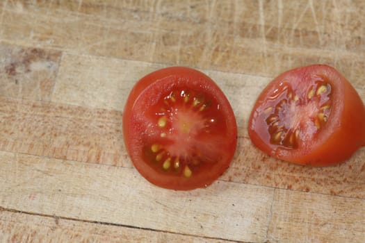 Tomato and black truffle isolated on a wooden cutting board