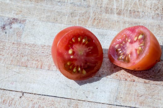 Tomato and black truffle isolated on a wooden cutting board