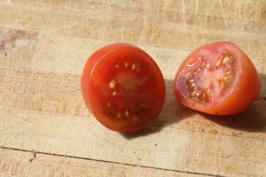 Tomato and black truffle isolated on a wooden cutting board