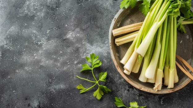 A white plate filled with fresh celery sticks sits on a wooden table. The celery is arranged neatly and is the main focal point of the image. The table is plain with no other objects in sight.