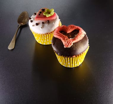 A delicious cupcake with heart on a black backround