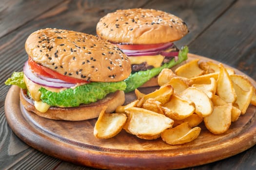 Two homemade hamburgers served with potato dippers