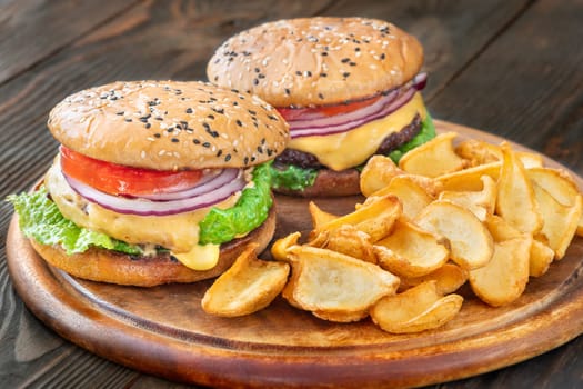 Two homemade hamburgers served with potato dippers