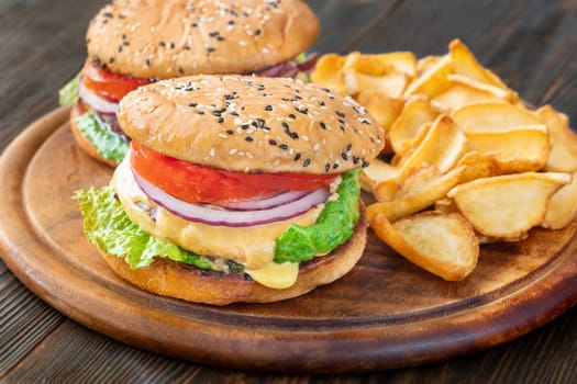 Two homemade hamburgers served with potato dippers