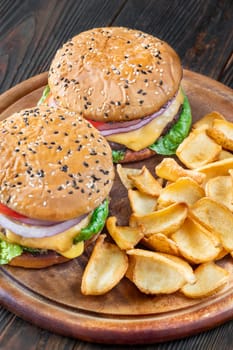 Two homemade hamburgers served with potato dippers