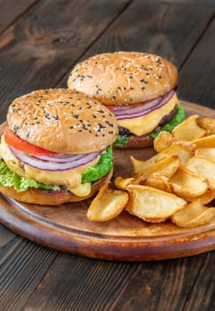 Two homemade hamburgers served with potato dippers