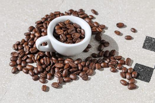 Close up of a cup of black coffee grains ad a cup