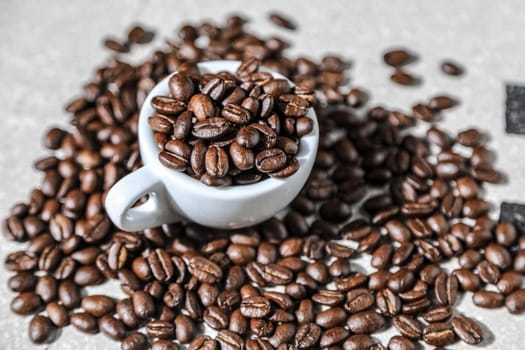 Close up of a cup of black coffee grains ad a cup