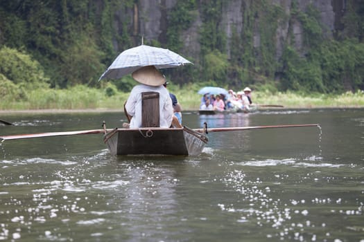 Boating on  the Mekong Delta with concal hats, Vietnam