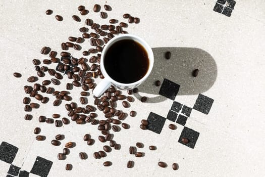 Close up of a cup of black coffee grains ad a cup