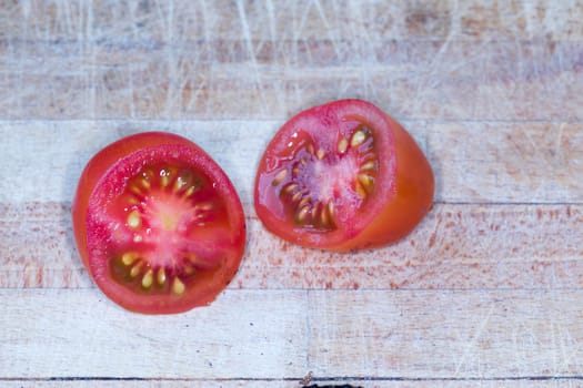 Tomato and black truffle isolated on a wooden cutting board